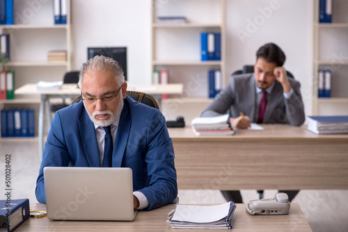 Two male colleagues working in the office
