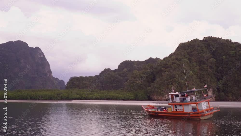 Local Fishing Boat at Sunset in Dreamy Tropical River Estuary at Low Tide - wide zoom Local Fishing Boat at Sunset in Dreamy Tropical River Estuary at Low Tide - wide zoom