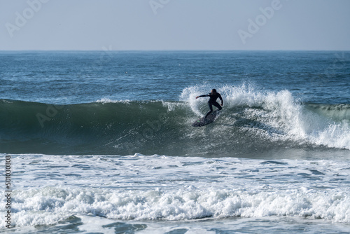 Surfer riding waves in Furadouro beach