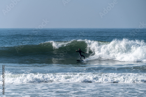 Surfer riding waves in Furadouro beach