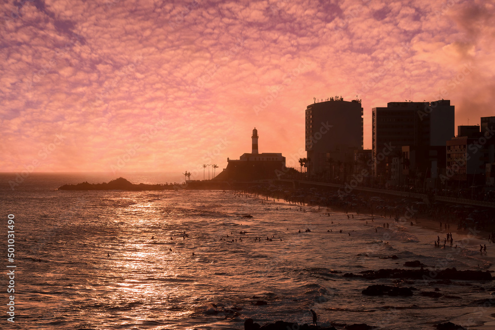 View of the sunset on the beach bar with the Barra Lighthouse in the background. View of the sunset on the beach bar with the Barra Lighthouse in the background.