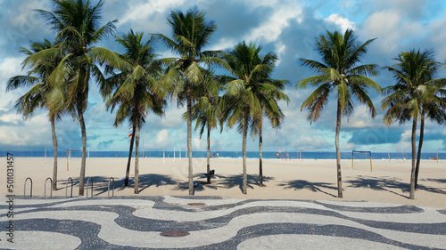 Copacabana Beach Rio de Janeiro boardwalk with palm trees and blue sky