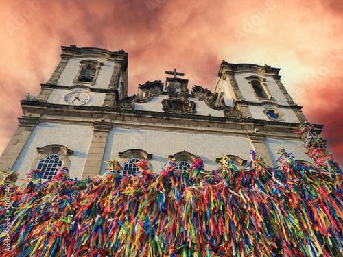 Bonfim Church facade with colored ribbons on the grid. photo