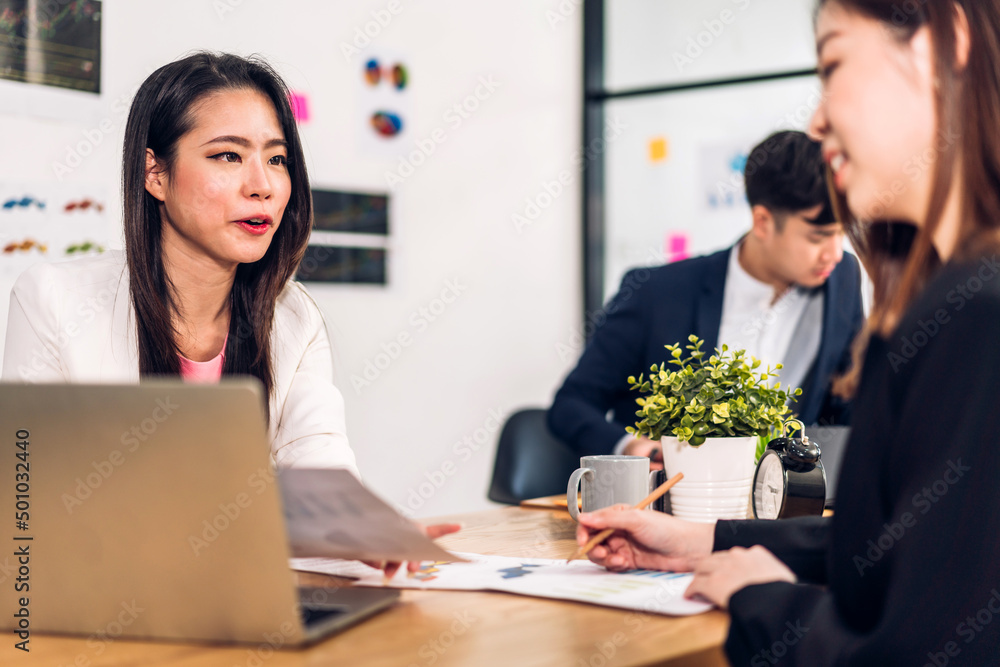 Fototapeta premium Group of asian business meeting and discussing strategy startup project analysis finance process.Success business people work plan and brainstorm marketing idea with laptop in office.Teamwork