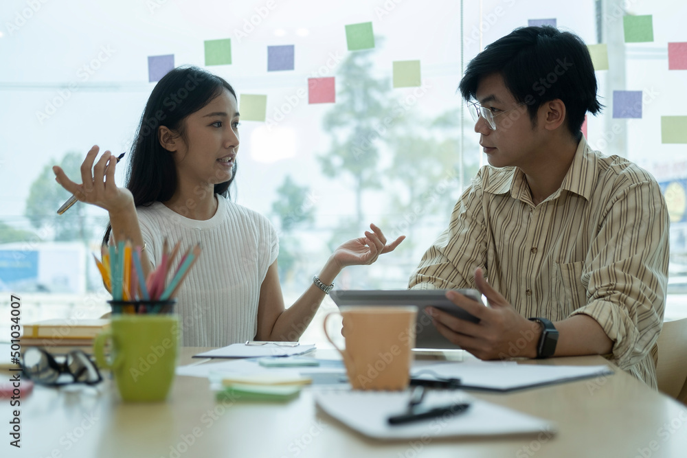 Young businesspeople discussing and planning startup project together. Young businesspeople discussing and planning startup project together.