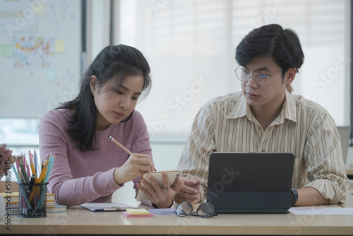 Two creative people working on new project together at office.