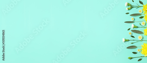 Many beautiful flowers and leaves on turquoise background with space for text