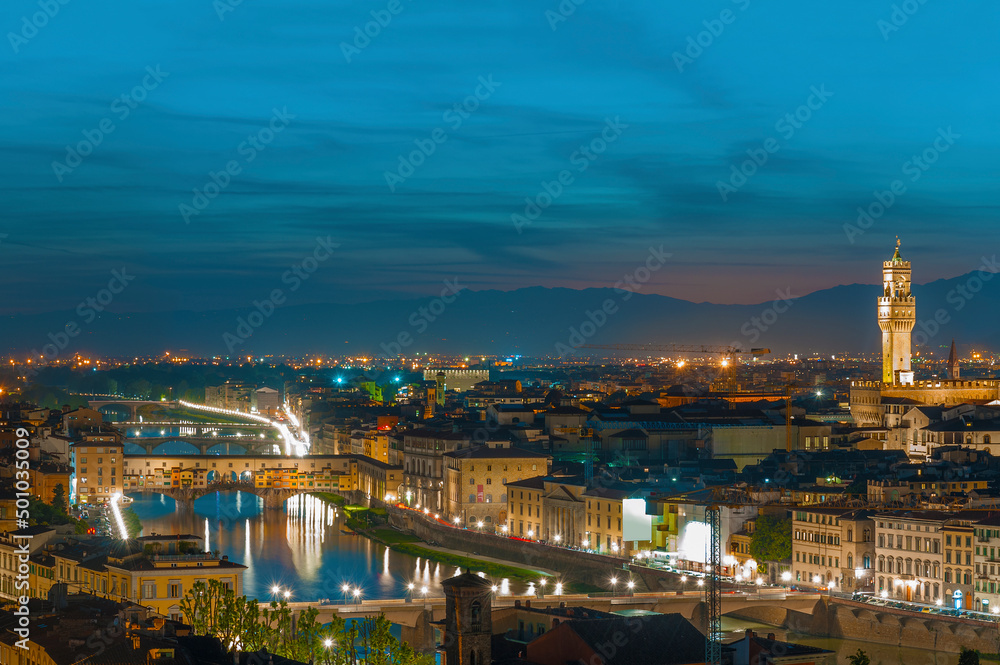 Florence city during sunset. Panoramic view to the river Arno, with Ponte Vecchio and  Palazzo Vecchio , Florence, Italy
