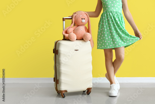 Cute little girl with suitc...