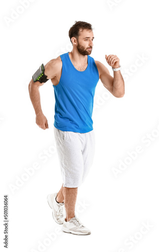 Sporty male runner on white...