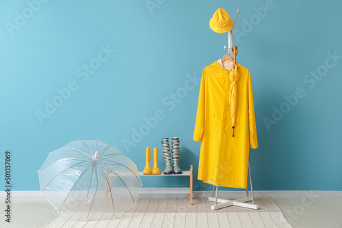 Raincoat, gumboots and umbrella in hallway