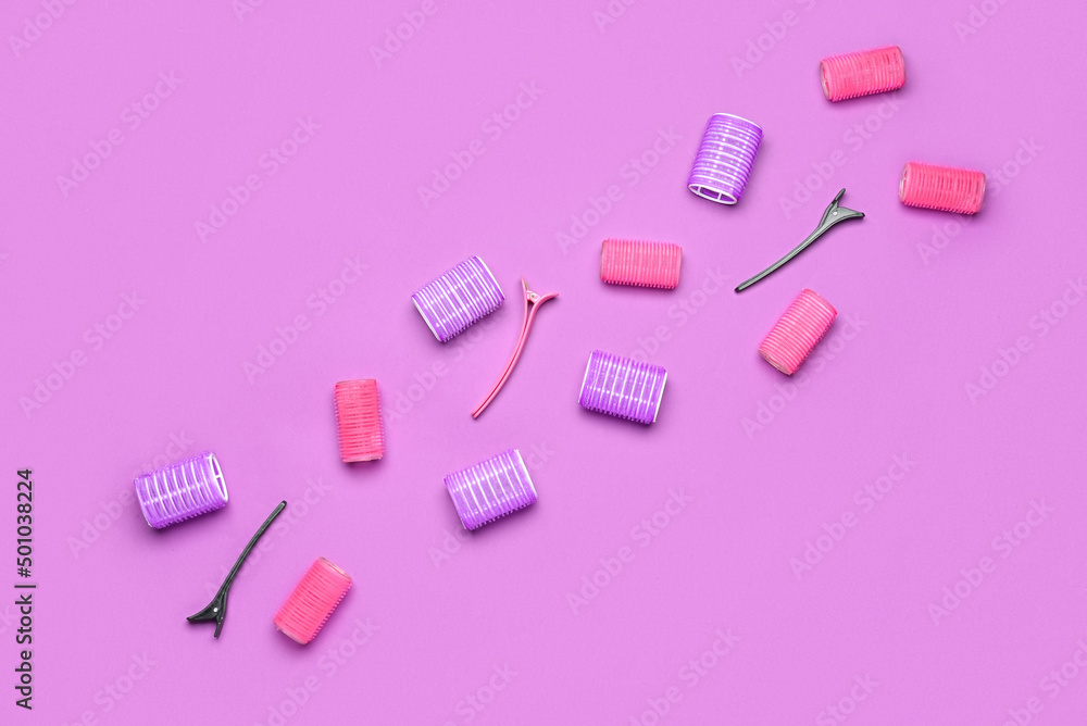 Hair curlers and clips on color background Hair curlers and clips on color background