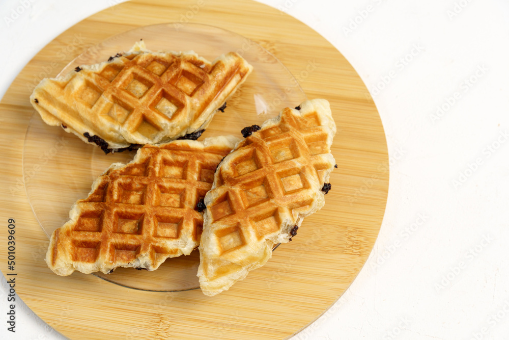 Croffles. Croissant dough is molded using a waffle mold. Flat lay Croffles. Croissant dough is molded using a waffle mold. Flat lay