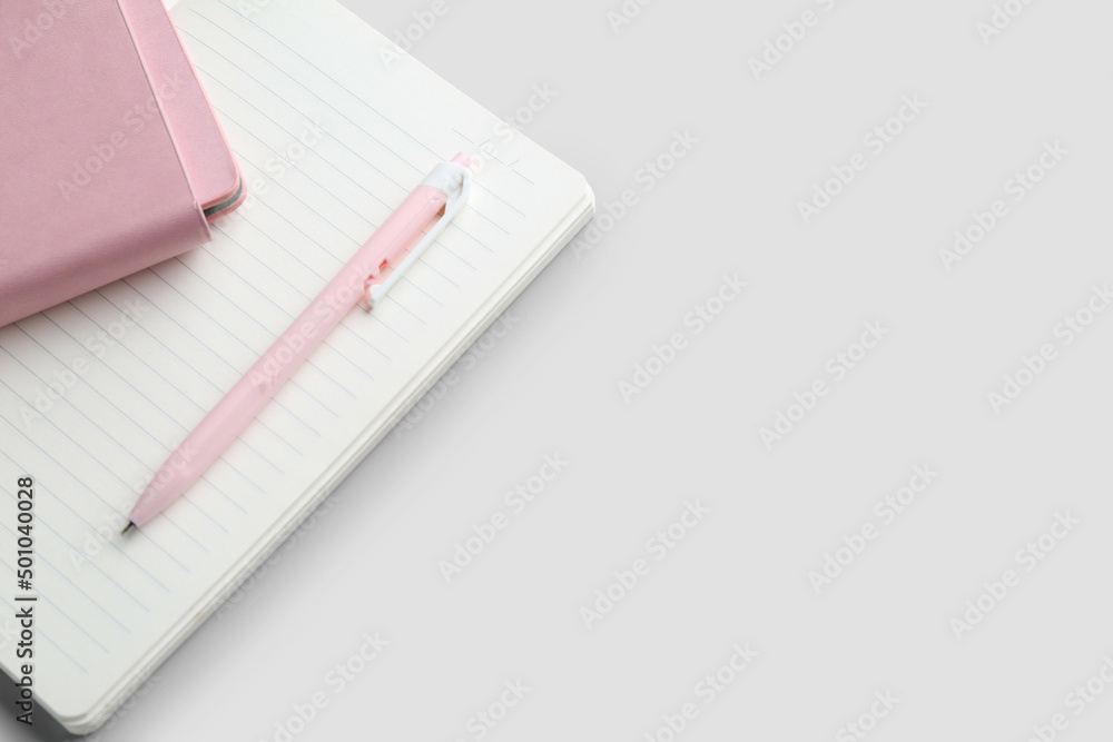 Notebooks and pen on light background Notebooks and pen on light background