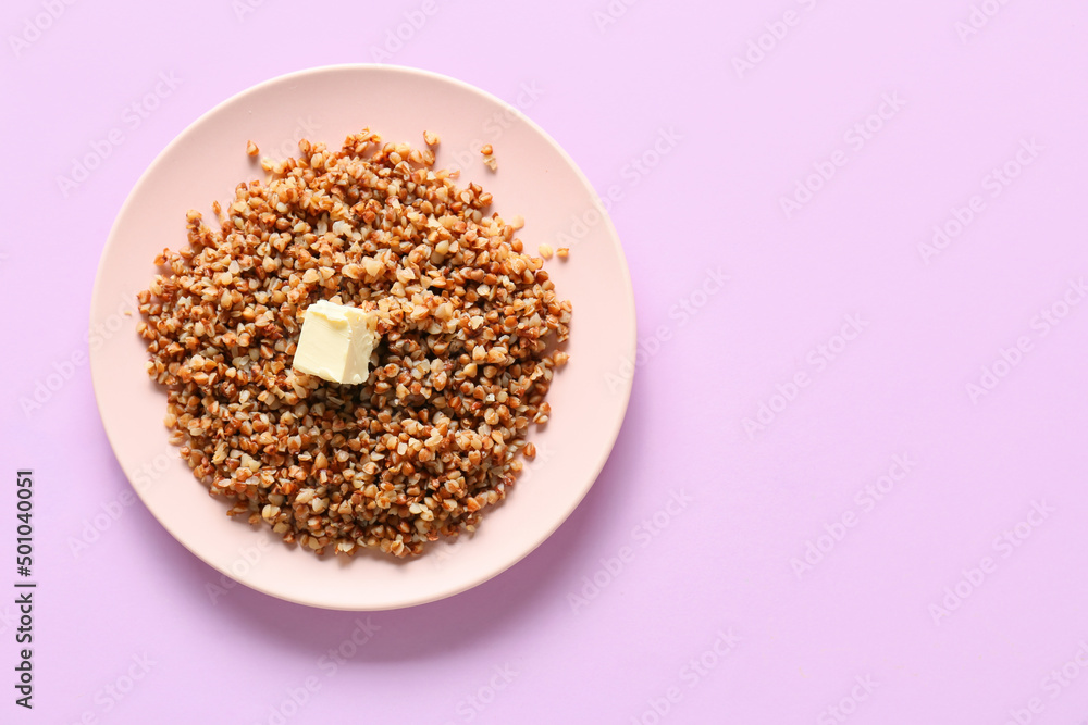 Plate of tasty buckwheat porridge on pink background Plate of tasty buckwheat porridge on pink background