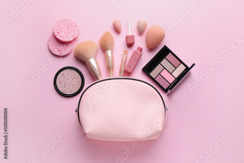 Bag with cosmetic products on pink background