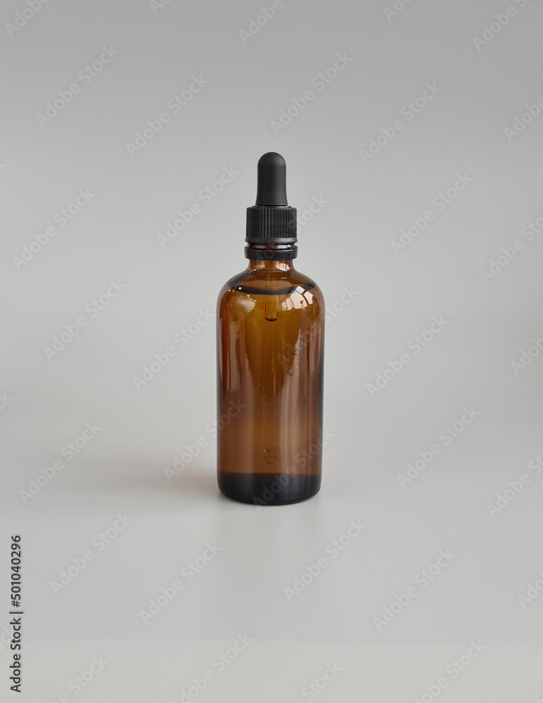 Glass bottle with oil for cosmetic product packaging mockup