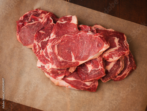 Grass Fed Rib-Eye Steaks on Parchment Paper photo