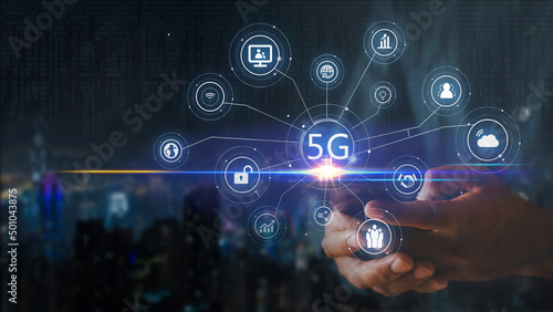 Hand of business man hold mobilephone connect network 5G with icon concept, technology network wireless systems and internet of things, new technologies coming up in the future. Network connection 5G