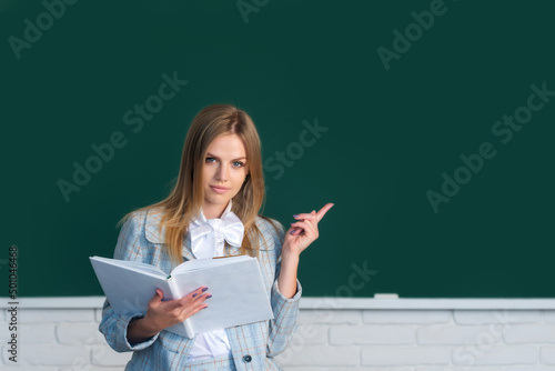Fotografía High school student learning english or mathematics in class, reading book