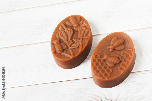 Rose Handmade Soap Take a photo with blooming roses On a white wooden floor., herbal soap., close-up photo.