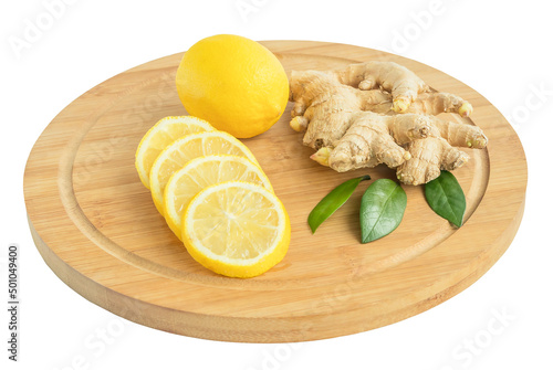 Fresh ginger roots with sliced lemon pieces and whole on a cutting kitchen board, white isolated background.