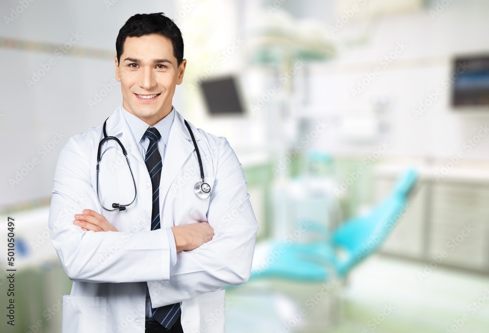 Dental doctor. Smiling Middle Dentist Doctor Stomatologist Standing With Folded Arms In Clinic Interior Dental doctor. Smiling Middle Dentist Doctor Stomatologist Standing With Folded Arms In Clinic Interior