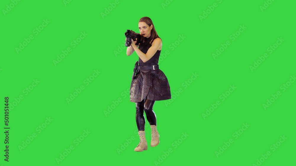 Cyberpunk girl walks with machine gun, taking an aim, making a single shot on a Green Screen, Chroma Key. Cyberpunk girl walks with machine gun, taking an aim, making a single shot on a Green Screen, Chroma Key.