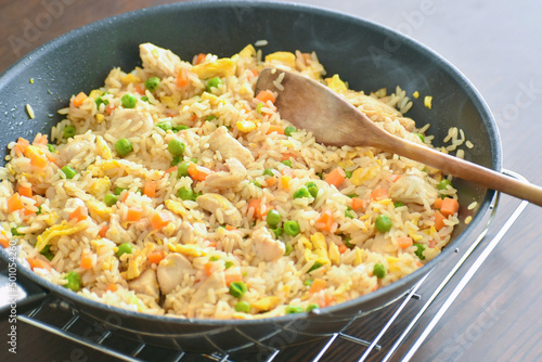 Chicken and egg fried rice in a frying pan. 