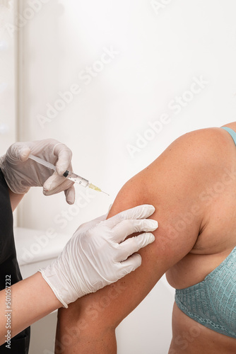 doctor cosmetologist makes an injection in the arm of the patient. mesotherapy procedure to remove excess fat from the body photo