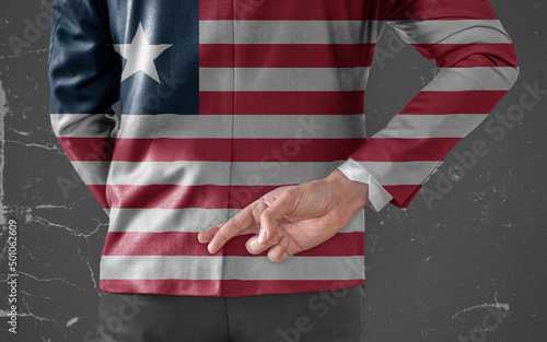 Businessman Jacket with Flag of Liberia with his fingers crossed behind his back
