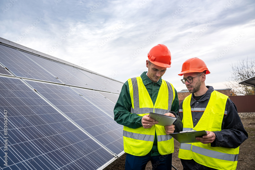 workers dressed in overalls came to inspect the solar panels. workers dressed in overalls came to inspect the solar panels.