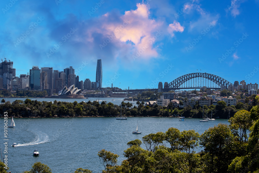 Naklejka premium Sydney Harbour Australia with nice colours in the sky. Nice blue water of the Harbour, high rise offices and residential buildings of the City in the background, NSW Australia