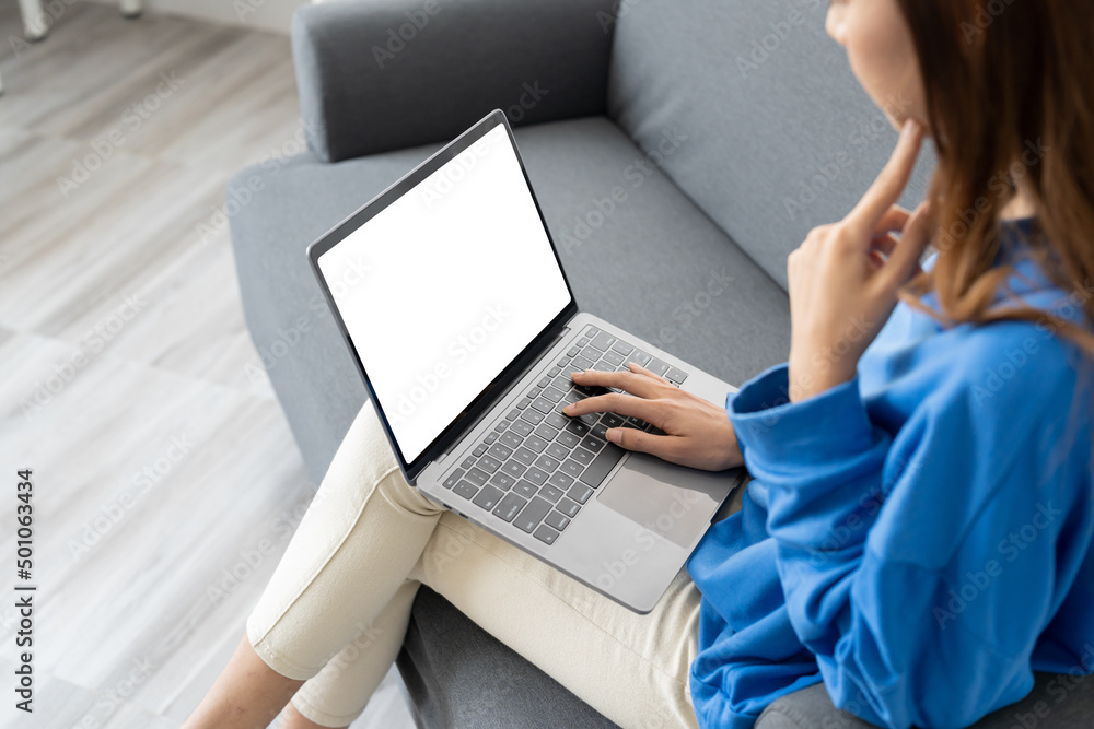 Top view of young woman working with laptop computer, empty screen display Top view of young woman working with laptop computer, empty screen display