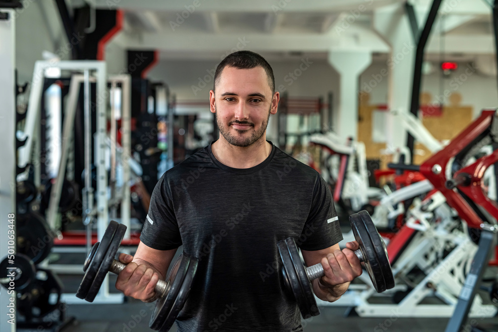 strong handsome man trainer in sporty fitted clothes trains his clients to improve health. strong handsome man trainer in sporty fitted clothes trains his clients to improve health.