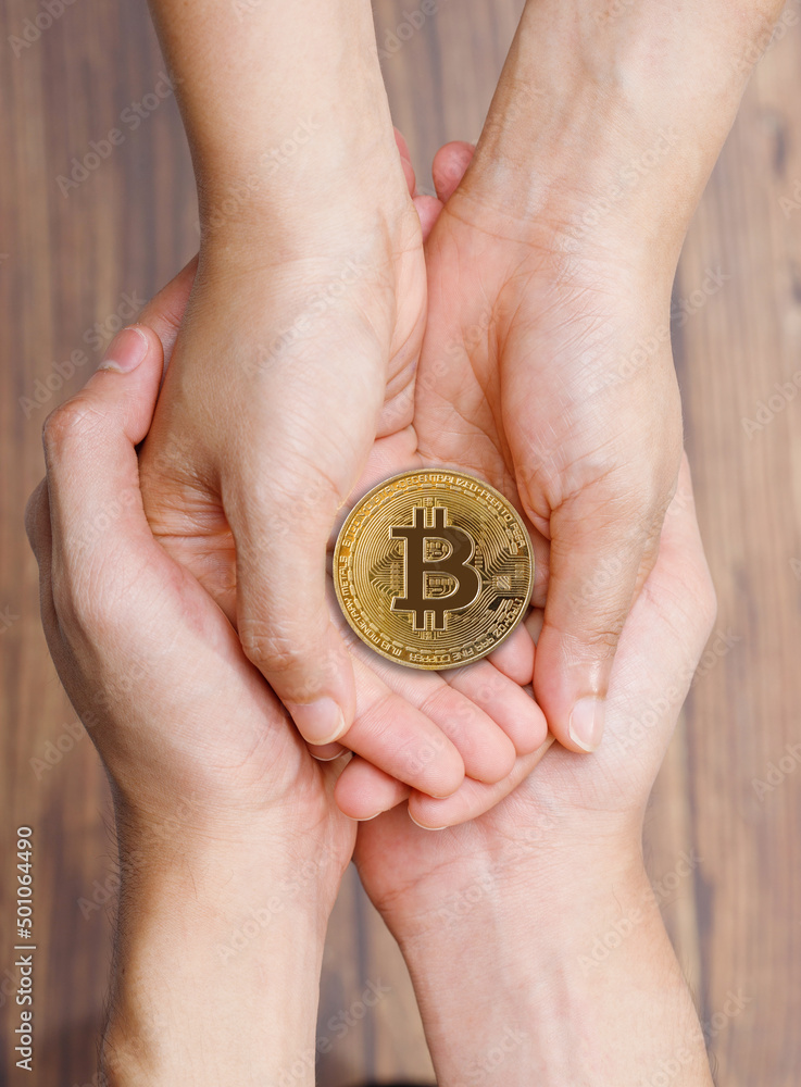 People Hand give and receive love of BTC Bitcoin on empty palm hands. Future of Crypto Currency will represent Heritage Gift to Family. Concept Love share with technology over wooden background People Hand give and receive love of BTC Bitcoin on empty palm hands. Future of Crypto Currency will represent Heritage Gift to Family. Concept Love share with technology over wooden background