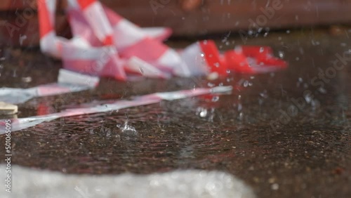 Water drips on the background of the warning tape