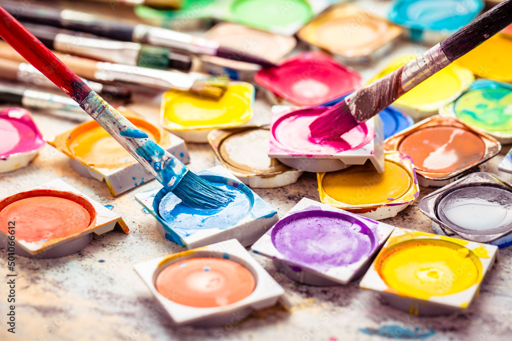 Obraz premium Colors and brushes on wooden background