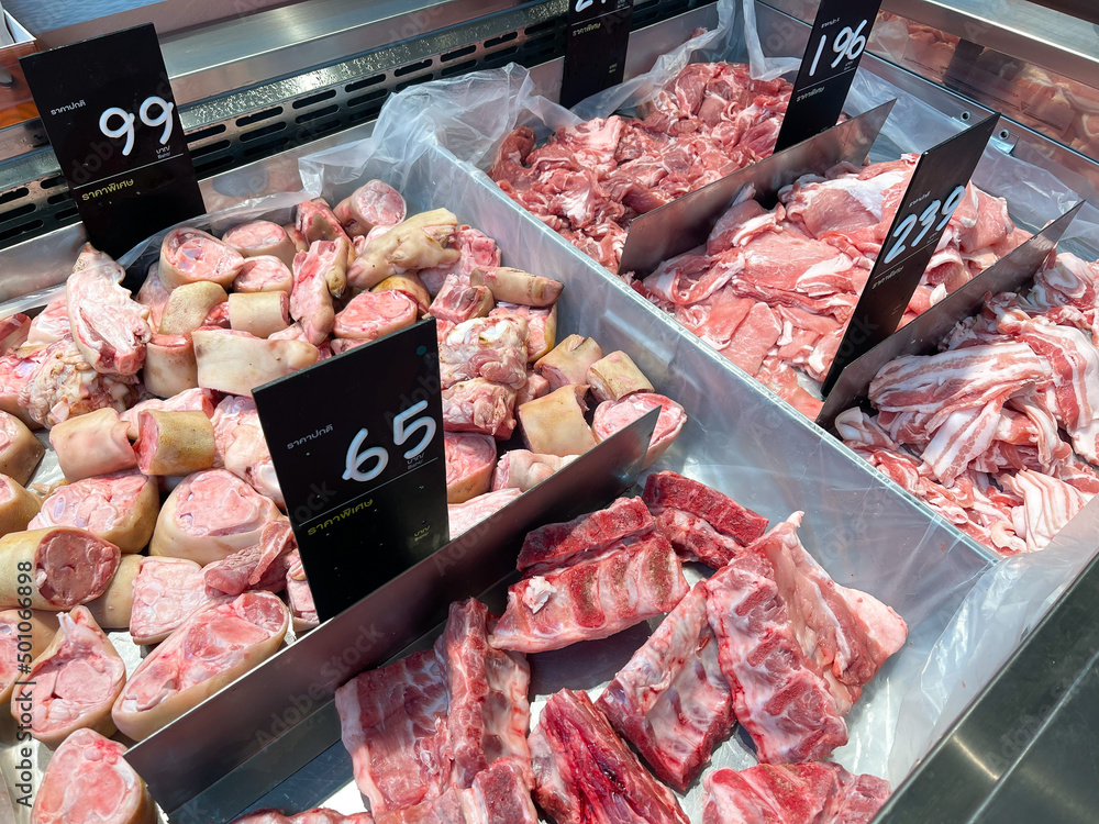 Different parts of meat pork display in supermarket. There is a price tag in Thai language.  Cooled fresh meat and good cuisine material.