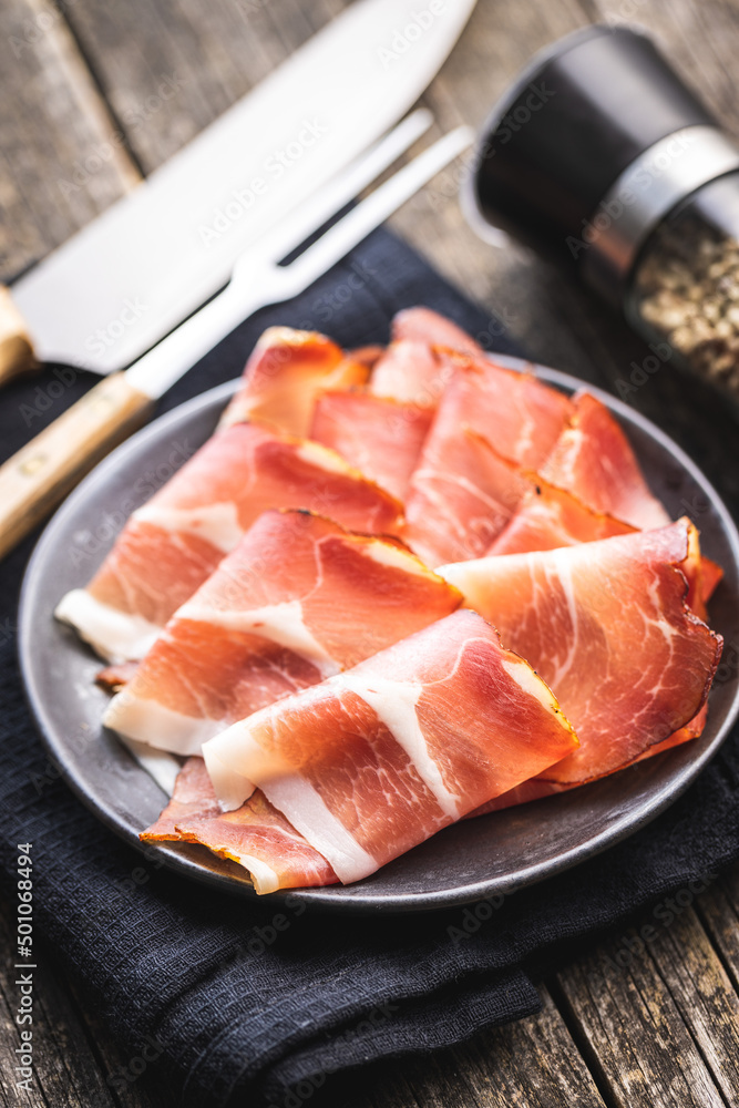 Sliced schwarzwald ham. Dried prosciutto ham on plate. Sliced schwarzwald ham. Dried prosciutto ham on plate.