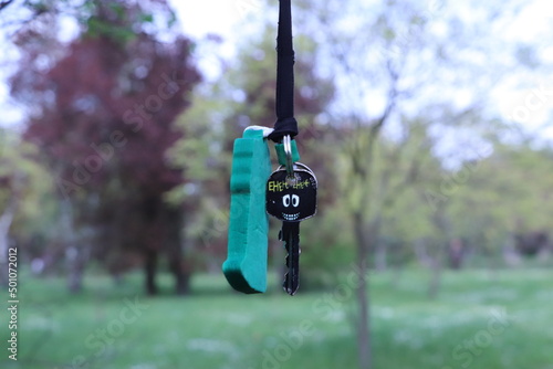 a key with a green pendant lost in the park