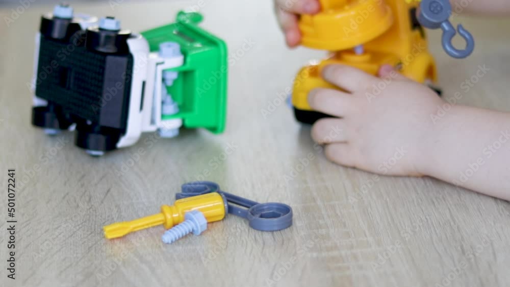 Construction machine. Enthusiastic, excited male kid and his mother or father are constructing assemble cars using plastic toy tools, screws, screwdriver.
crane and truck. Construction machine. Enthusiastic, excited male kid and his mother or father are constructing assemble cars using plastic toy tools, screws, screwdriver.
crane and truck.