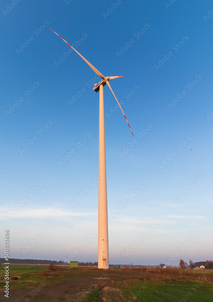 view of a working wind generator standing in the field. view of a working wind generator standing in the field.