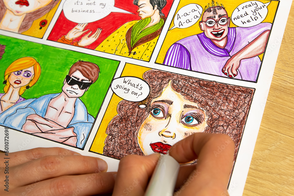 Designer Drawing Comics The artist designer draws sketches of comic book characters on paper ...