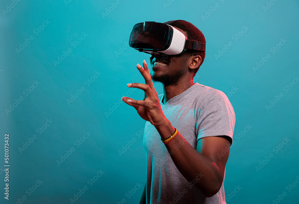Young man having fun with interactive virtual reality headset, using ...