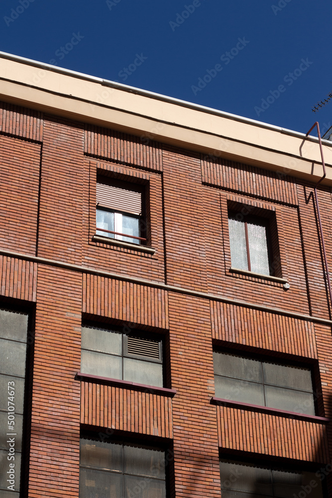 red brick faccade with industrial windows and deep blue sky red brick faccade with industrial windows and deep blue sky