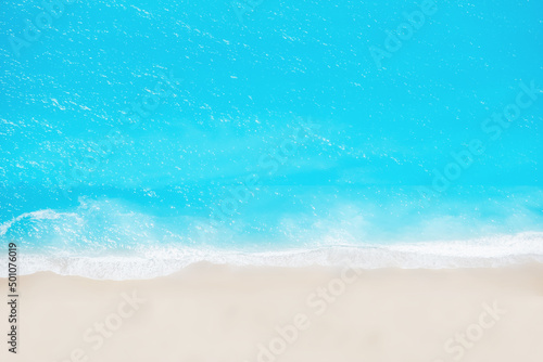Fototapeta Naklejka Na Ścianę i Meble -  Beach and waves from top view. Turquoise water background from top view. Summer seascape from air. Top view from drone. Travel concept and idea