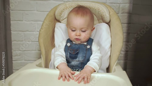 baby sits in chair and waits to be fed