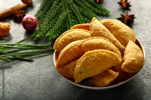 Homemade fresh baked curry puffs on a rustic kitchen table background.