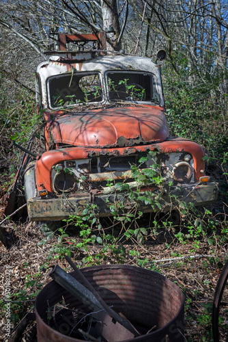 At the junkyard. Abandoned tow truck. overgrown by blackberry Perished agricultural history. Abandoned and rusted machinery. 